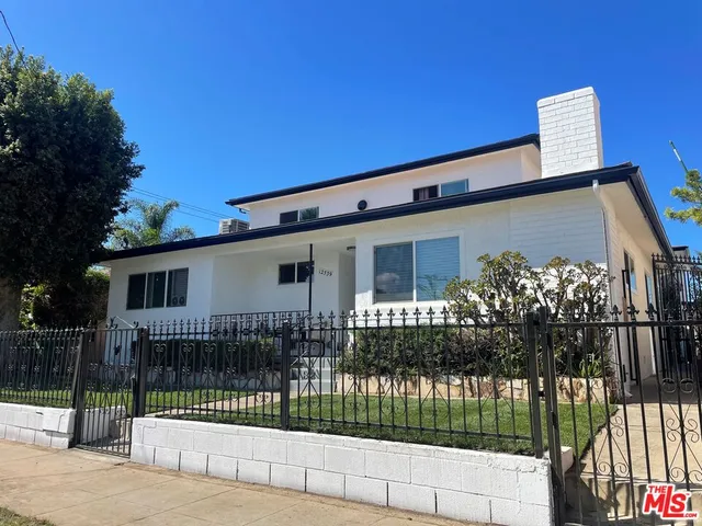 a front view of a house with a fence