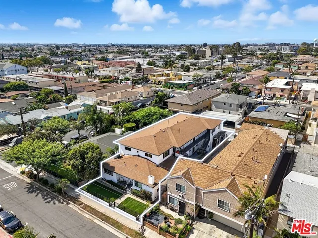 an aerial view of a residential apartment building with parking space