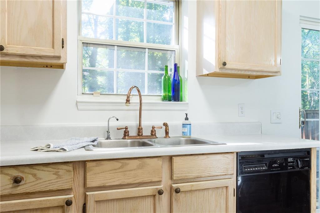 4908 Tarleton Drive Southwest Lilburn, GA 30047 - Photo 11 of 41 a kitchen with appliances cabinets and a window