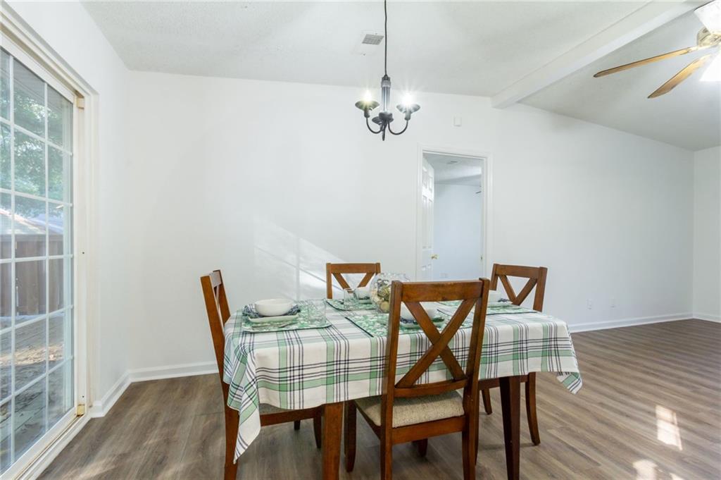 4908 Tarleton Drive Southwest Lilburn, GA 30047 - Photo 12 of 41 a view of a dining room with furniture and wooden floor
