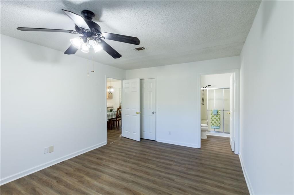 4908 Tarleton Drive Southwest Lilburn, GA 30047 - Photo 15 of 41 a view of empty room with wooden floor and fan