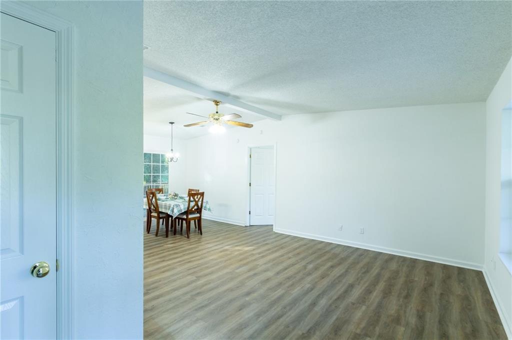 4908 Tarleton Drive Southwest Lilburn, GA 30047 - Photo 2 of 41 a view of a room with wooden floor table and chairs