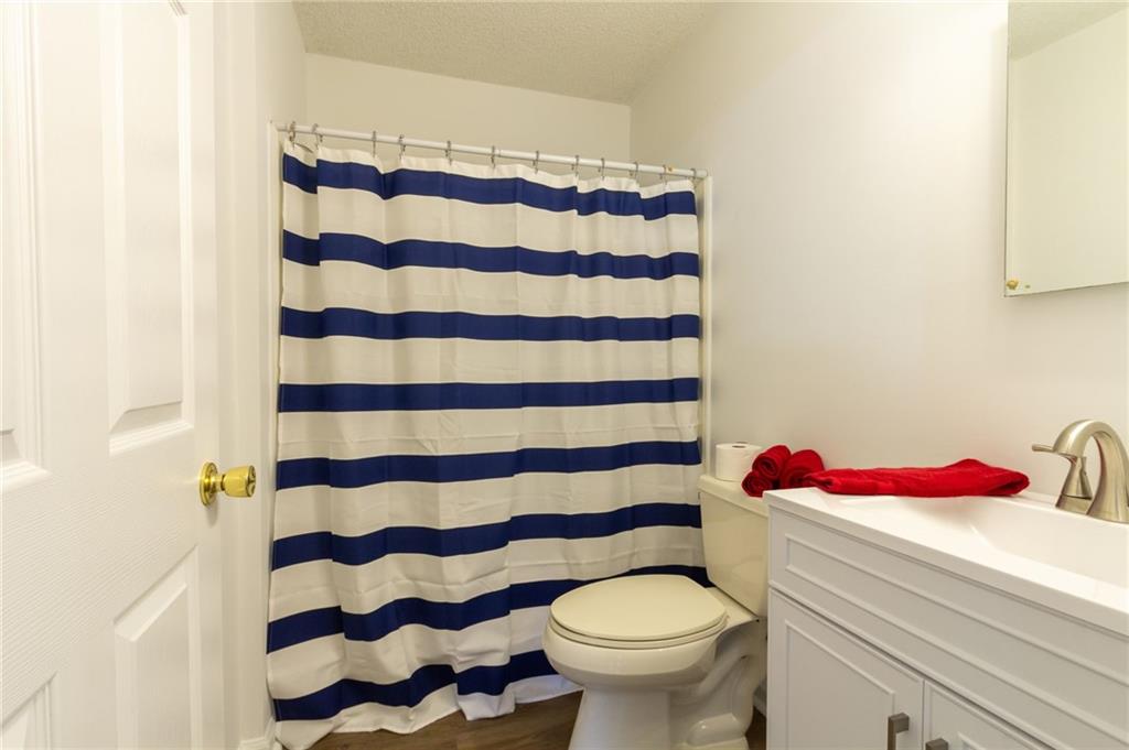 4908 Tarleton Drive Southwest Lilburn, GA 30047 - Photo 22 of 41 a bathroom with a sink and a toilet