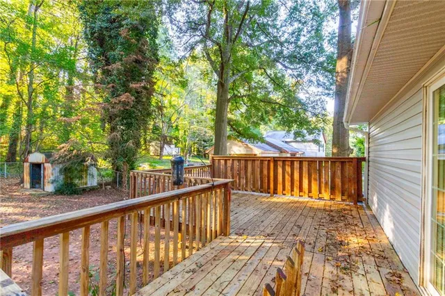 a view of balcony with wooden floor and fence