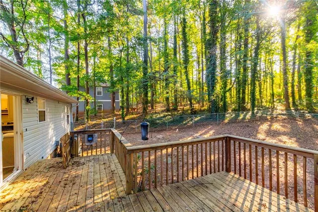 a view of house with backyard and deck