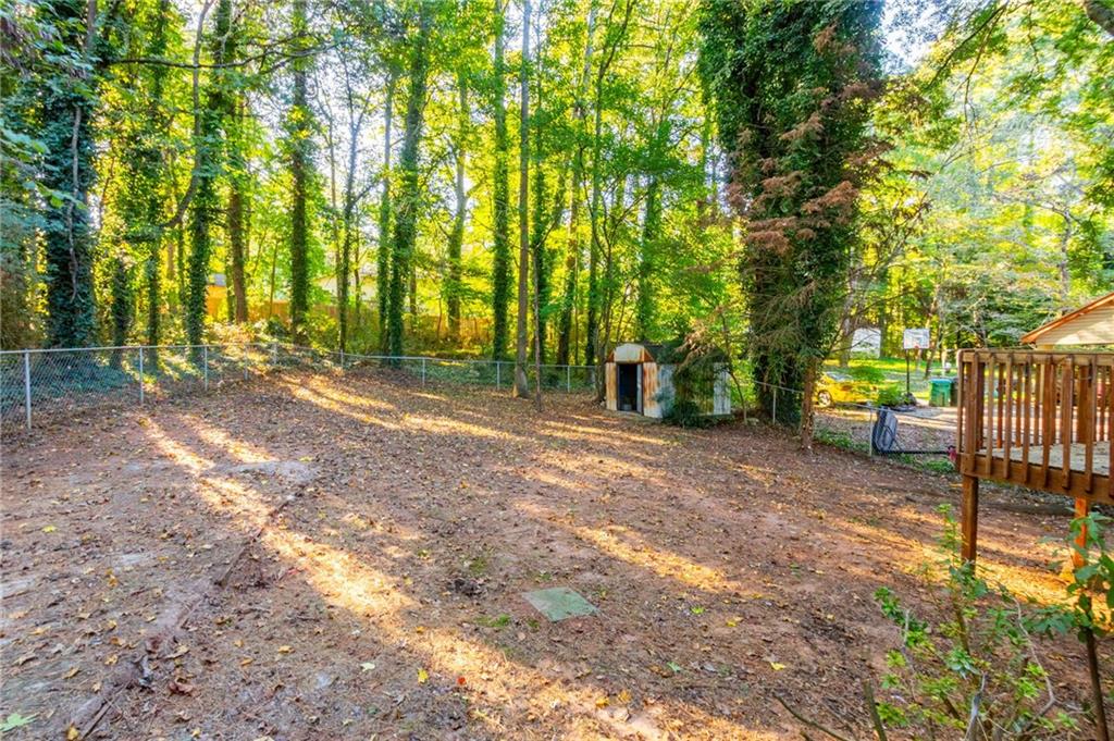 4908 Tarleton Drive Southwest Lilburn, GA 30047 - Photo 26 of 41 a view of outdoor space with deck and tree