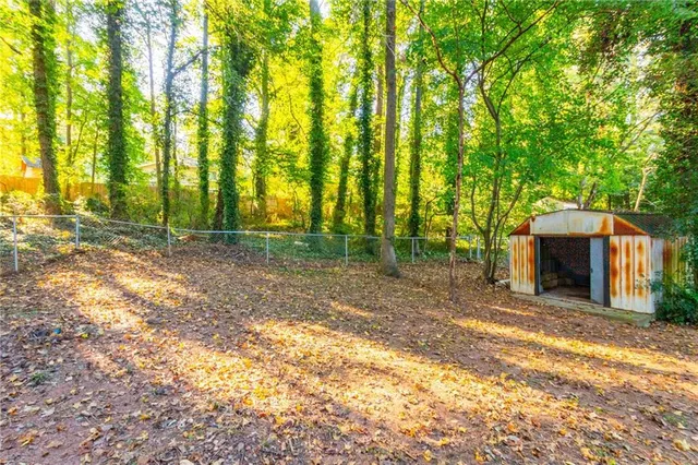 a view of house with backyard and trees