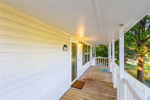 a view of a balcony with floor to ceiling window wooden floor and fence