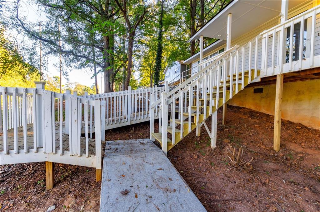 4908 Tarleton Drive Southwest Lilburn, GA 30047 - Photo 33 of 41 a view of a house with backyard and deck