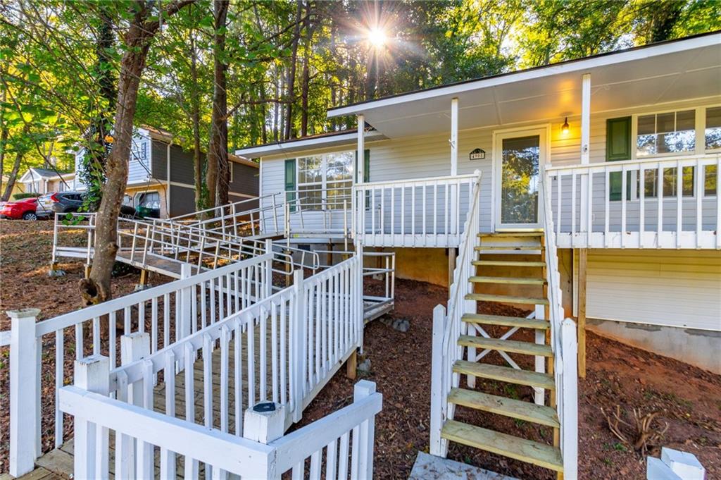 4908 Tarleton Drive Southwest Lilburn, GA 30047 - Photo 35 of 41 front view of a house with a deck