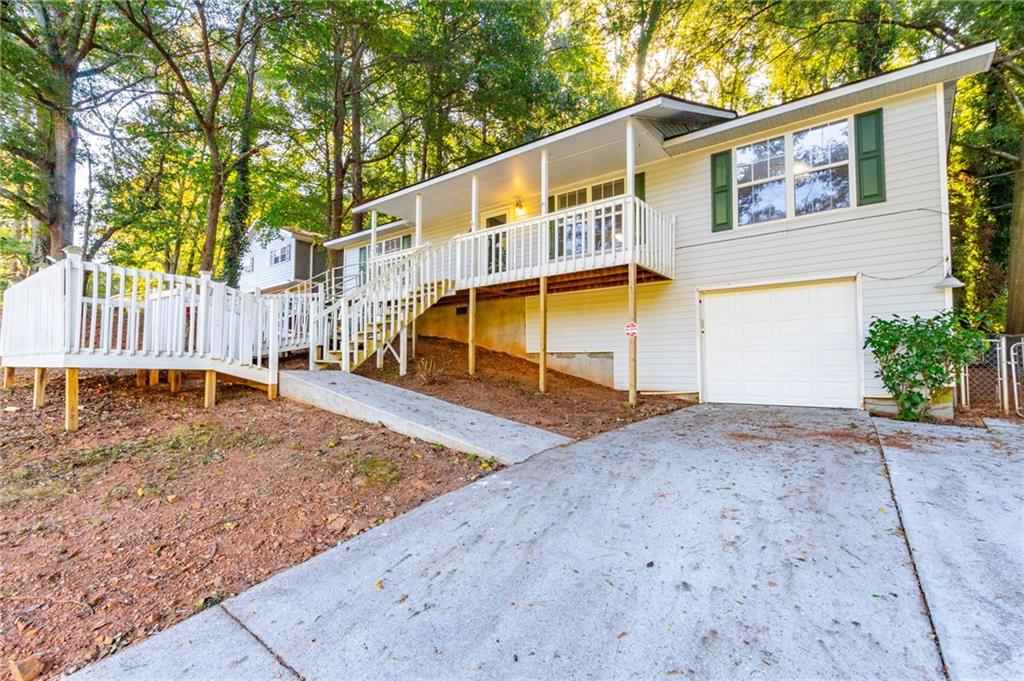 4908 Tarleton Drive Southwest Lilburn, GA 30047 - Photo 38 of 41 a view of a house with a yard