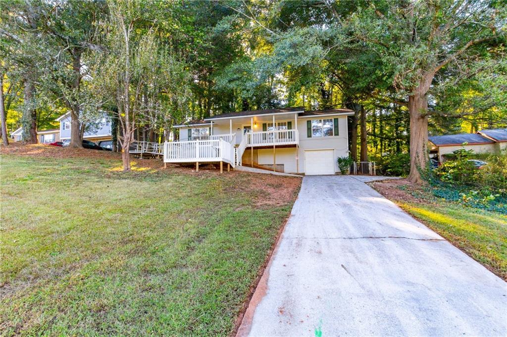 4908 Tarleton Drive Southwest Lilburn, GA 30047 - Photo 39 of 41 a house with trees in front of it