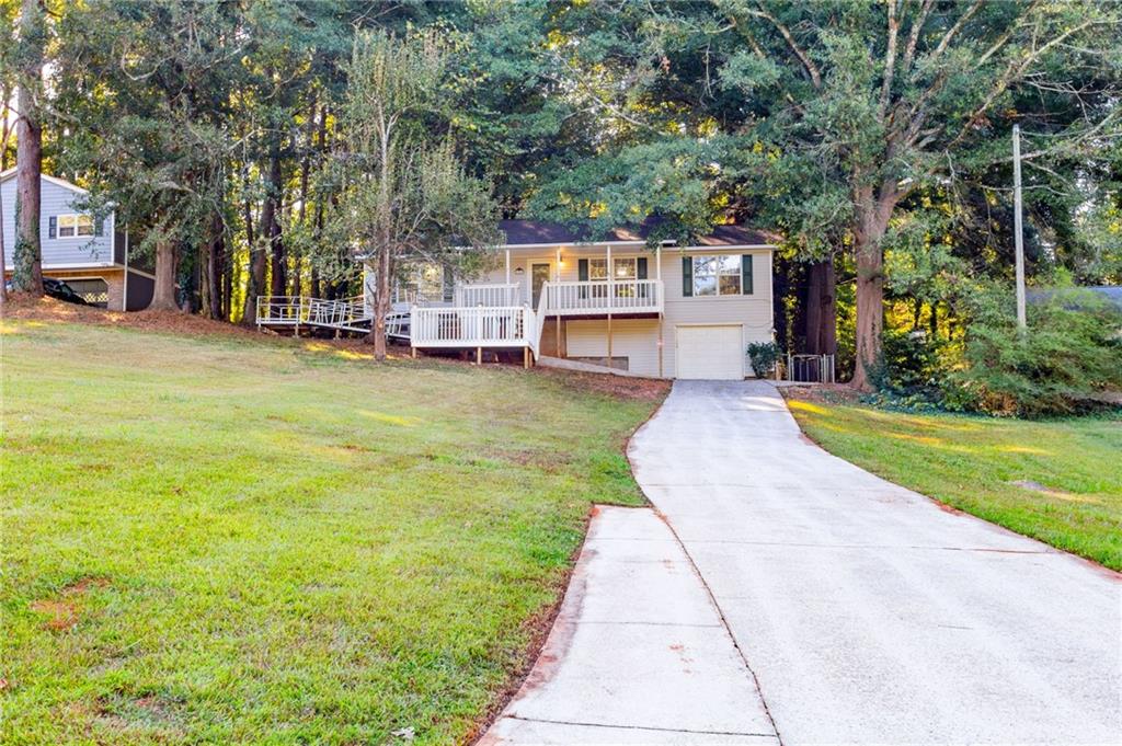 4908 Tarleton Drive Southwest Lilburn, GA 30047 - Photo 41 of 41 a swimming pool with outdoor seating and yard