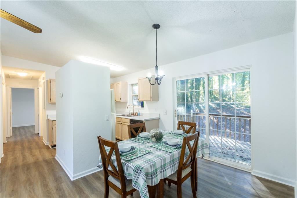 4908 Tarleton Drive Southwest Lilburn, GA 30047 - Photo 5 of 41 a view of a dining room with furniture window and wooden floor