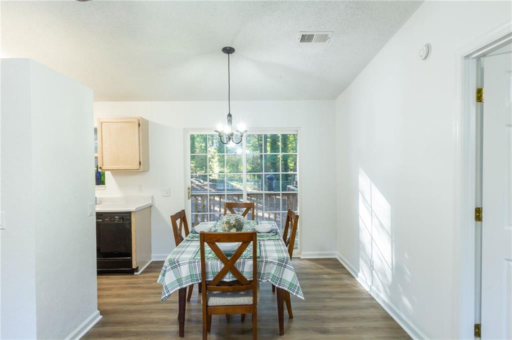 4908 Tarleton Drive Southwest Lilburn, GA 30047 - Photo 6 of 41 a view of a dining room with furniture window and wooden floor