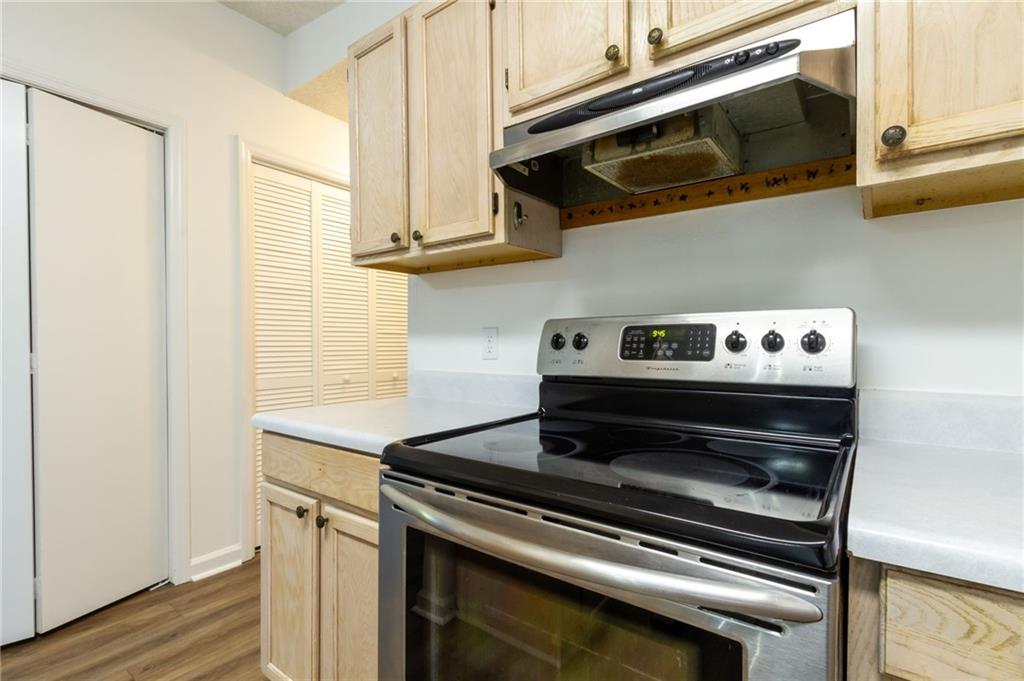 4908 Tarleton Drive Southwest Lilburn, GA 30047 - Photo 9 of 41 a kitchen with stainless steel appliances granite countertop a stove and a microwave