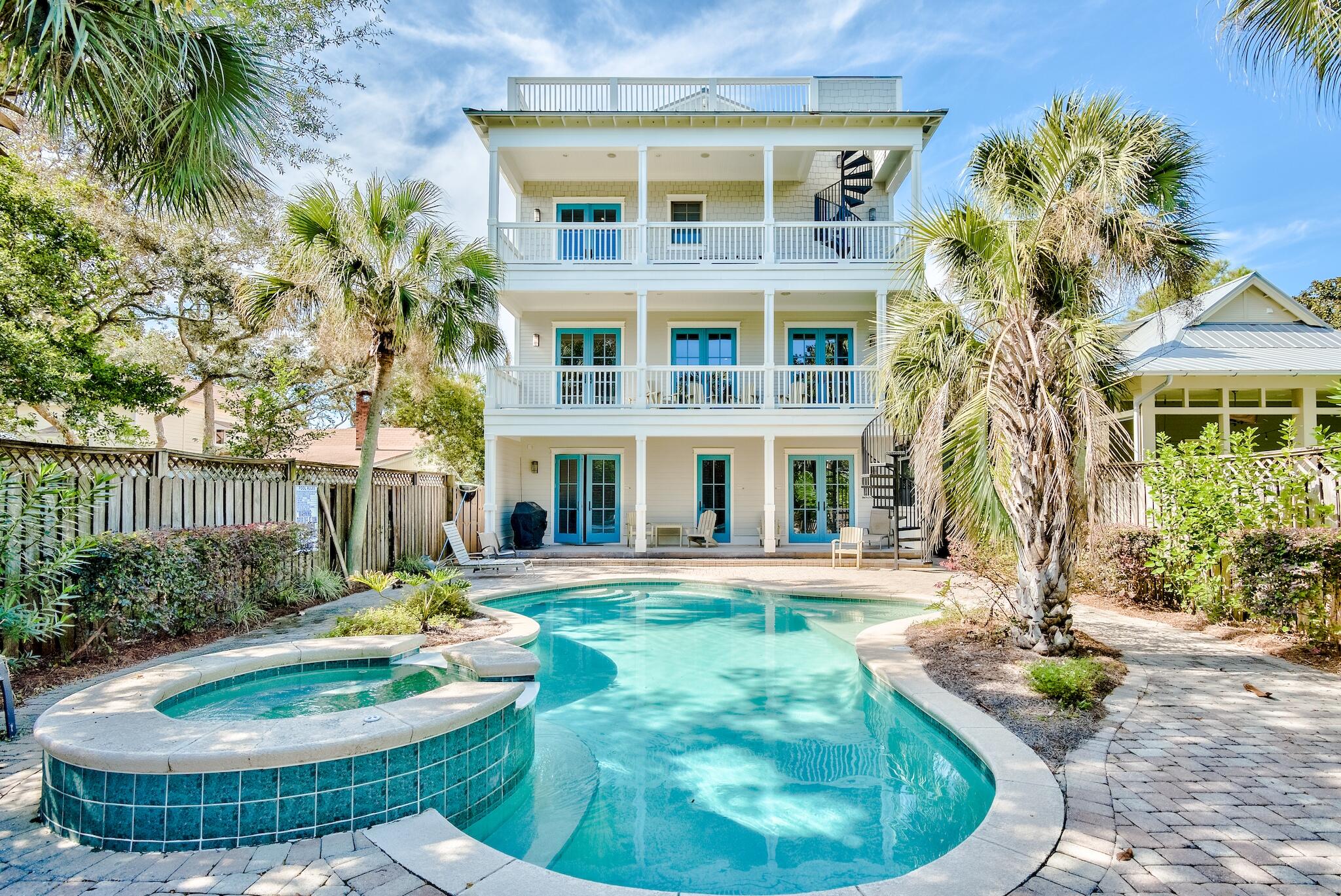 a view of a house with a swimming pool and sitting area