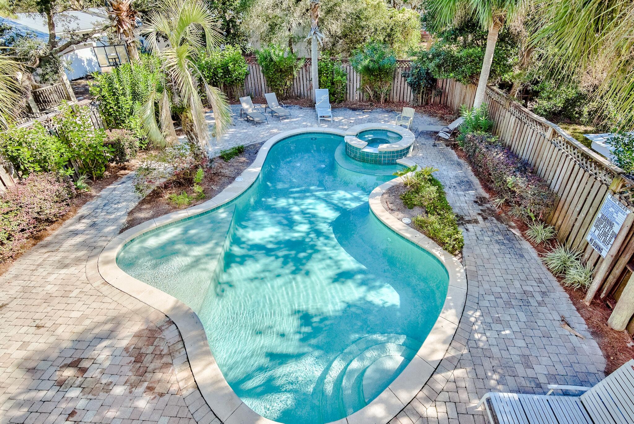 433 Defuniak Street Santa Rosa Beach, FL 32459 - Photo 11 of 57 a view of a backyard with sitting area