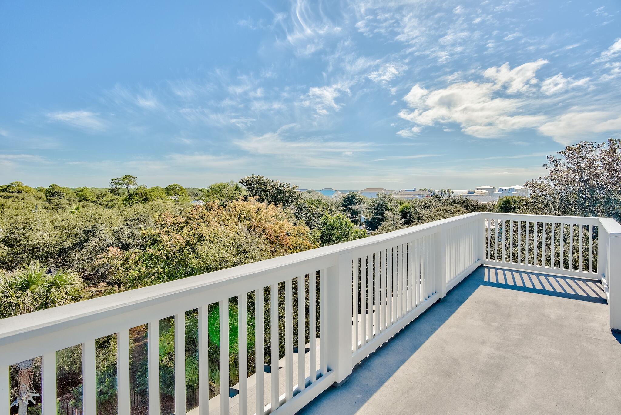 433 Defuniak Street Santa Rosa Beach, FL 32459 - Photo 16 of 57 a balcony with wooden floor and city view