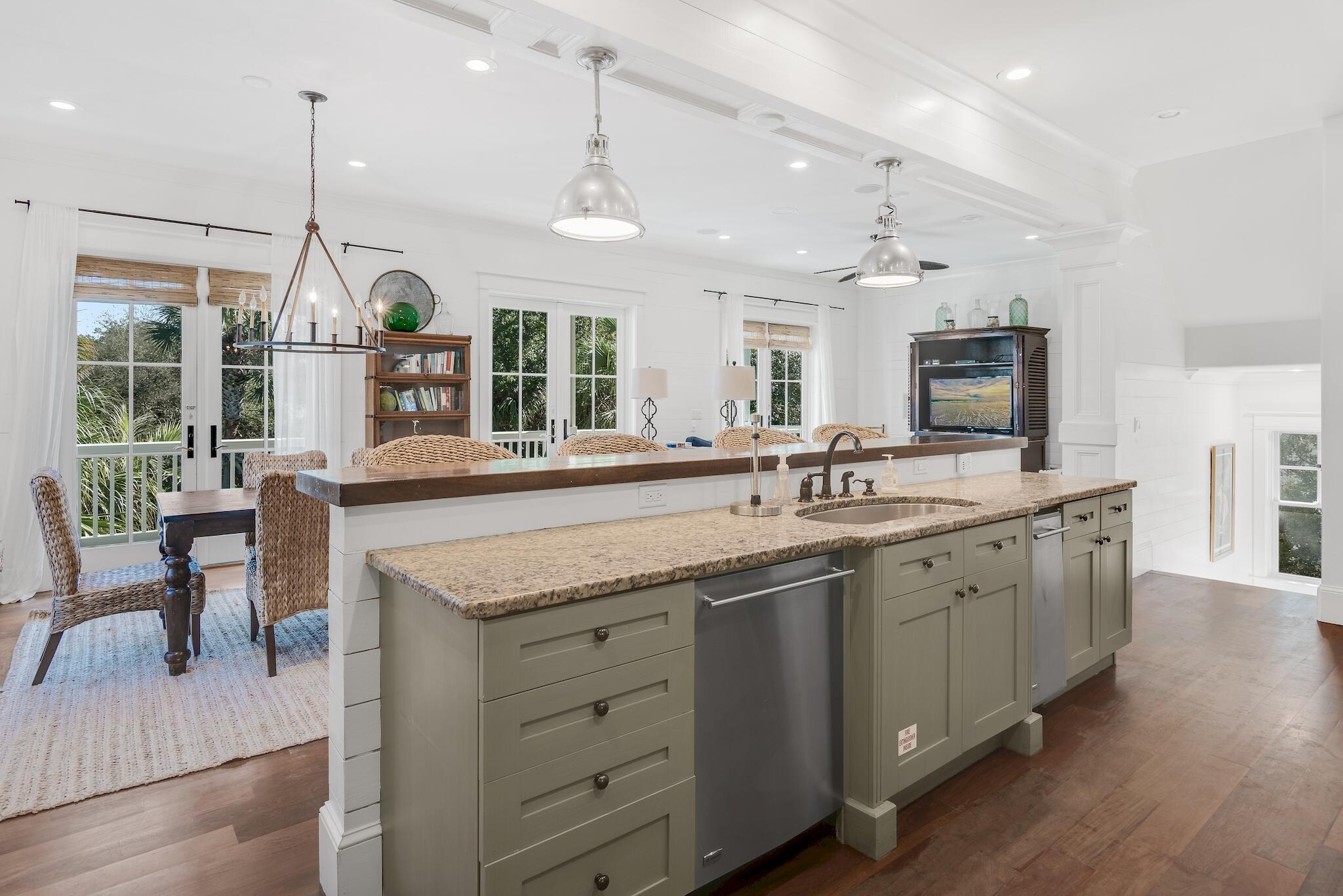 433 Defuniak Street Santa Rosa Beach, FL 32459 - Photo 24 of 57 a open kitchen with stainless steel appliances granite countertop a sink a stove and a wooden floors