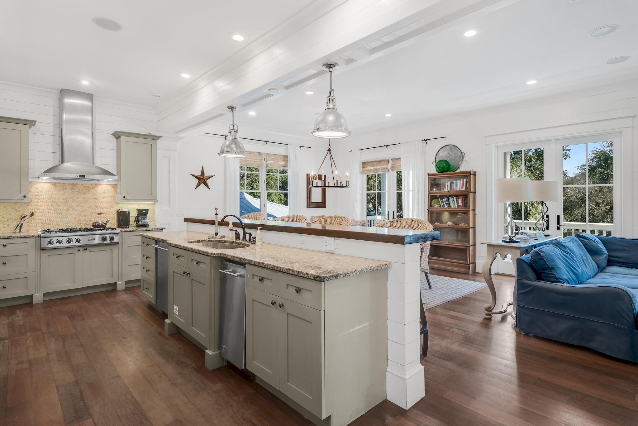 433 Defuniak Street Santa Rosa Beach, FL 32459 - Photo 25 of 57 a large kitchen with kitchen island a large counter space a sink stainless steel appliances and cabinets