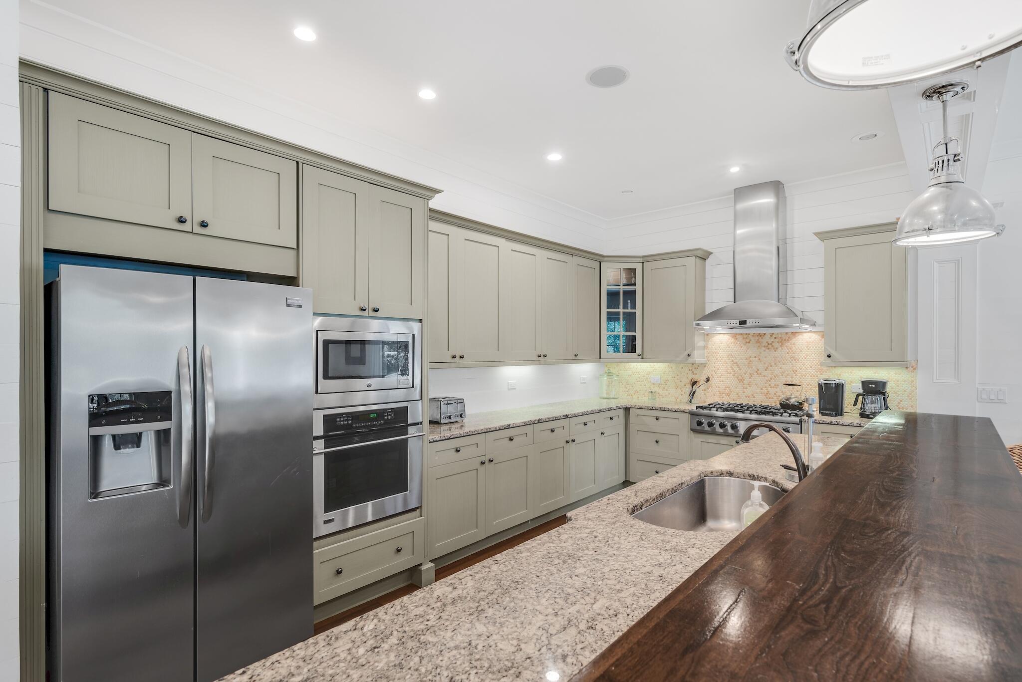 433 Defuniak Street Santa Rosa Beach, FL 32459 - Photo 26 of 57 a kitchen with cabinets and stainless steel appliances
