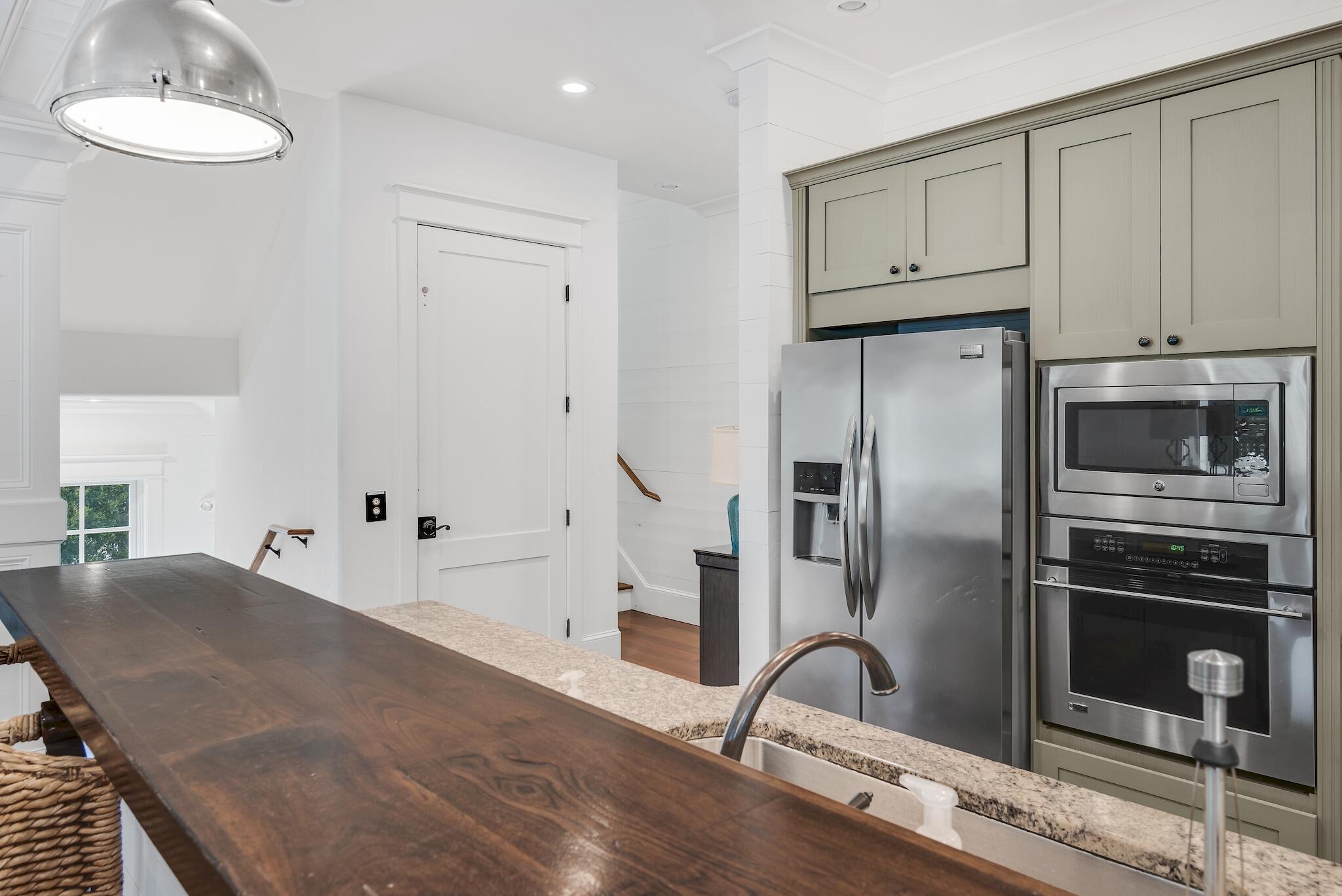 433 Defuniak Street Santa Rosa Beach, FL 32459 - Photo 27 of 57 a kitchen with stainless steel appliances granite countertop a refrigerator and a stove top oven