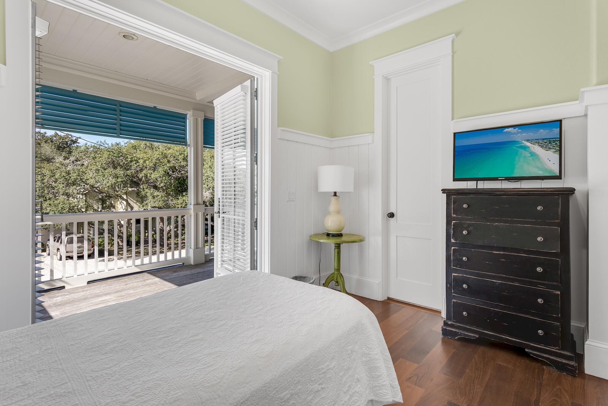 433 Defuniak Street Santa Rosa Beach, FL 32459 - Photo 29 of 57 a bedroom with a bed and a flat tv screen