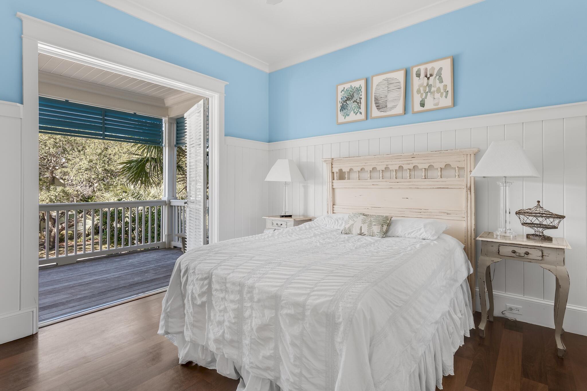 433 Defuniak Street Santa Rosa Beach, FL 32459 - Photo 30 of 57 a bedroom with a bed and wooden floor