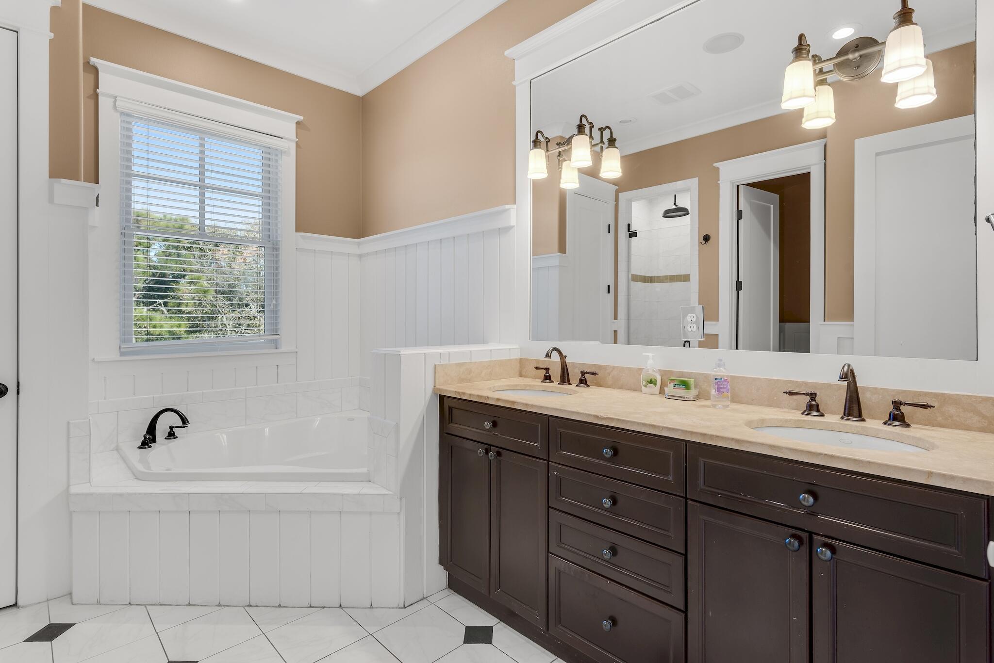 433 Defuniak Street Santa Rosa Beach, FL 32459 - Photo 36 of 57 a bathroom with a tub double sink and mirror