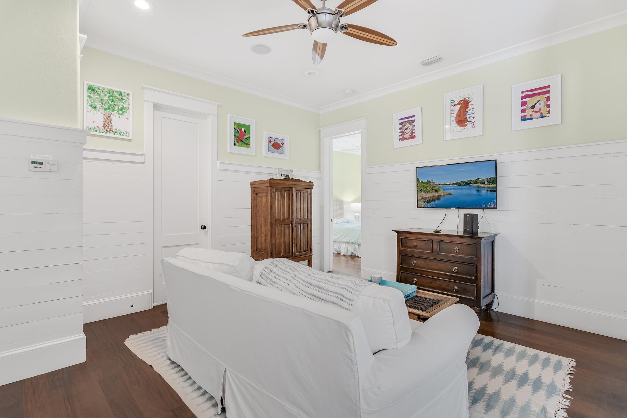 433 Defuniak Street Santa Rosa Beach, FL 32459 - Photo 44 of 57 a bedroom with a bed and a chandelier