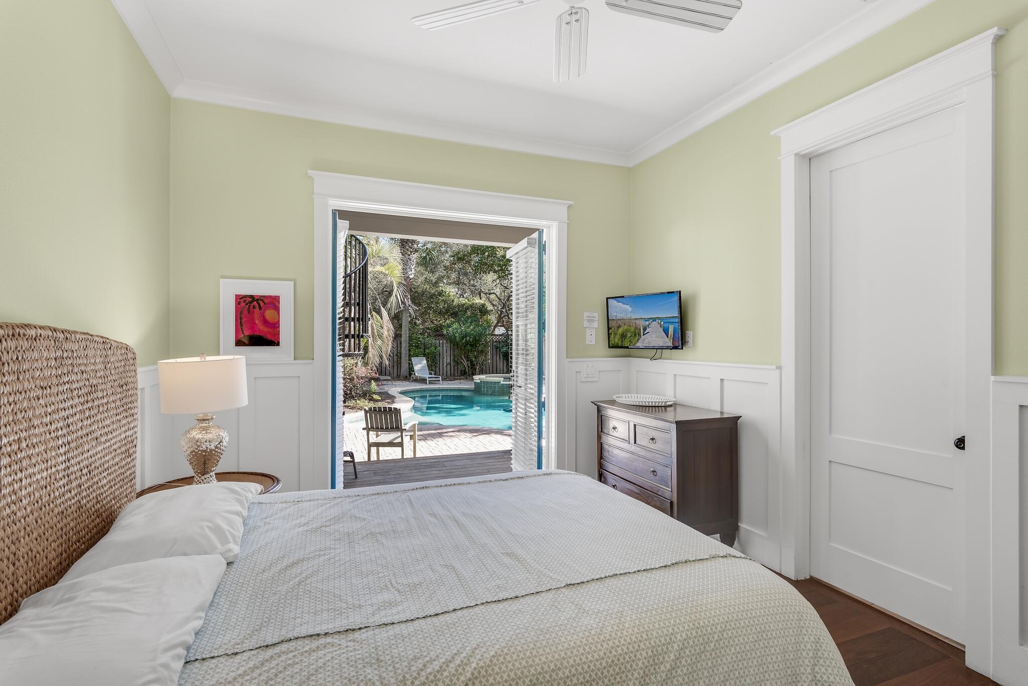 433 Defuniak Street Santa Rosa Beach, FL 32459 - Photo 50 of 57 a bedroom with a bed and a dresser next to a window