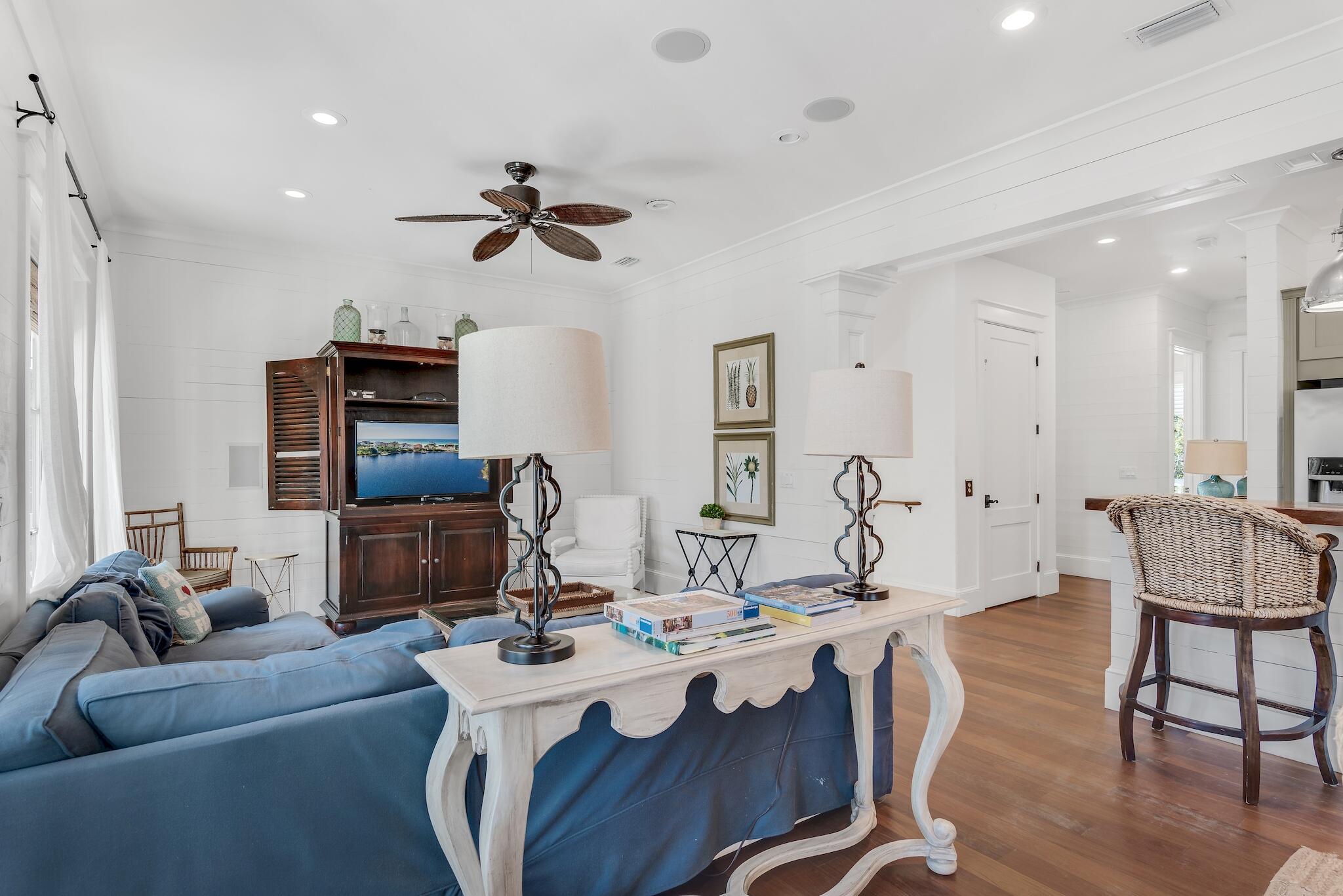 433 Defuniak Street Santa Rosa Beach, FL 32459 - Photo 8 of 57 a living room with furniture a ceiling fan and a wooden floor