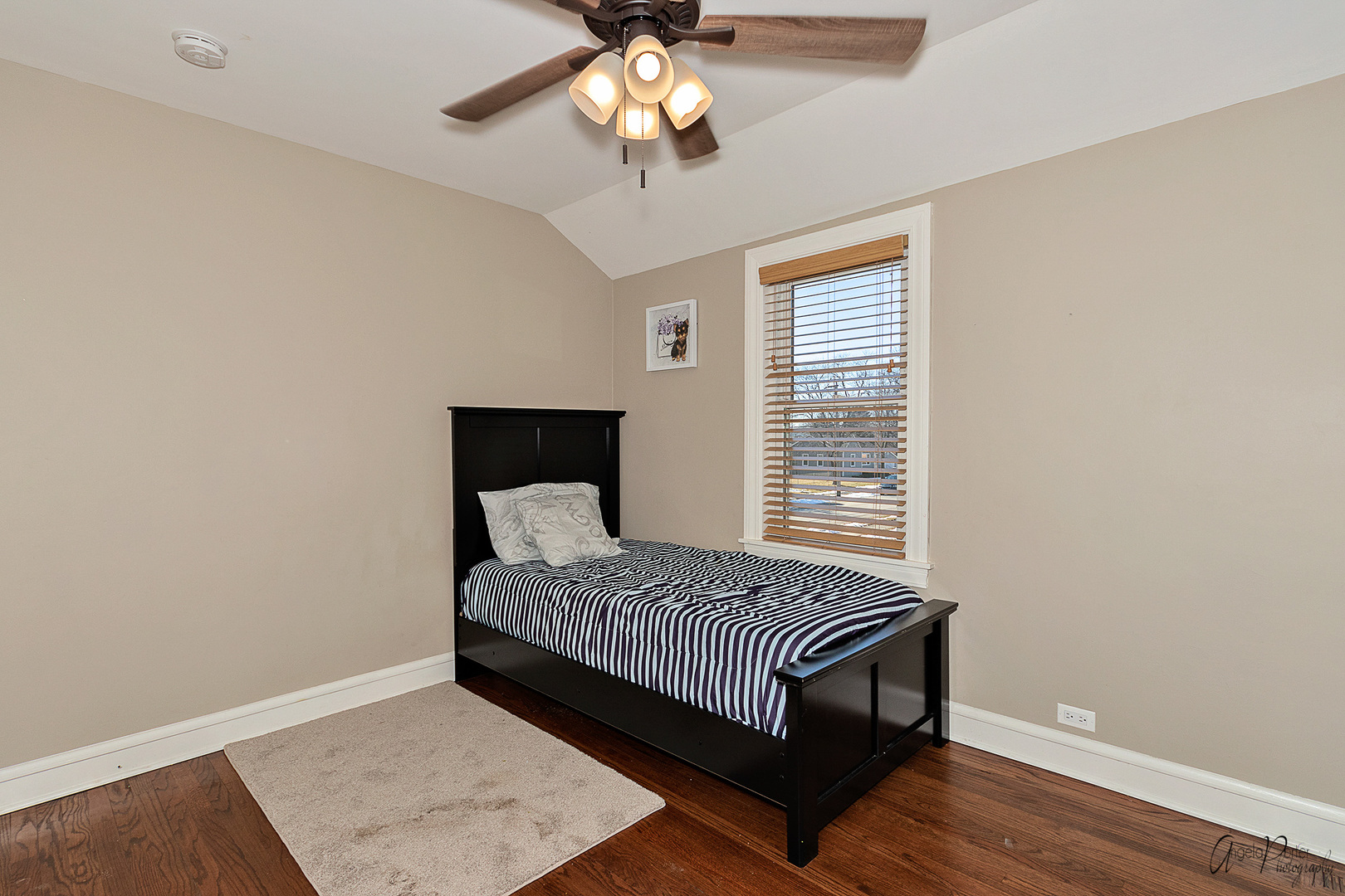 5824 Prospect Avenue Berkeley, IL 60163 - Photo 14 of 26 a bedroom with a bed and a chandelier