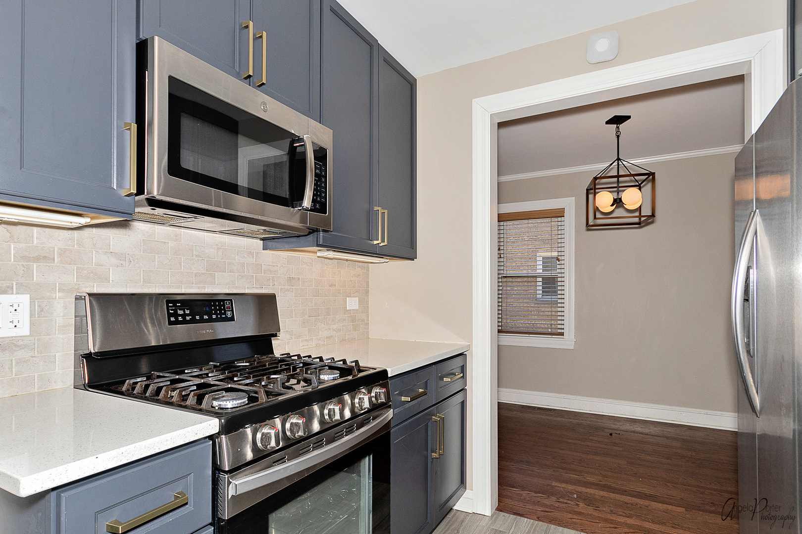 5824 Prospect Avenue Berkeley, IL 60163 - Photo 2 of 26 a kitchen with stainless steel appliances a stove a microwave and cabinets
