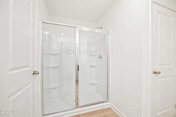 a bathroom with a glass shower door
