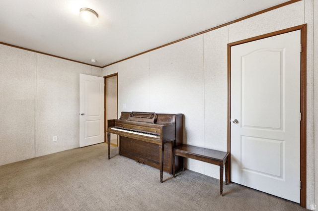 2875 North Hill Field Road, Unit 62 Layton, UT 84041 - Photo 21 of 34 Neutral tone-on-tone carpeting complements vertical wall paneling with wood-finish trim