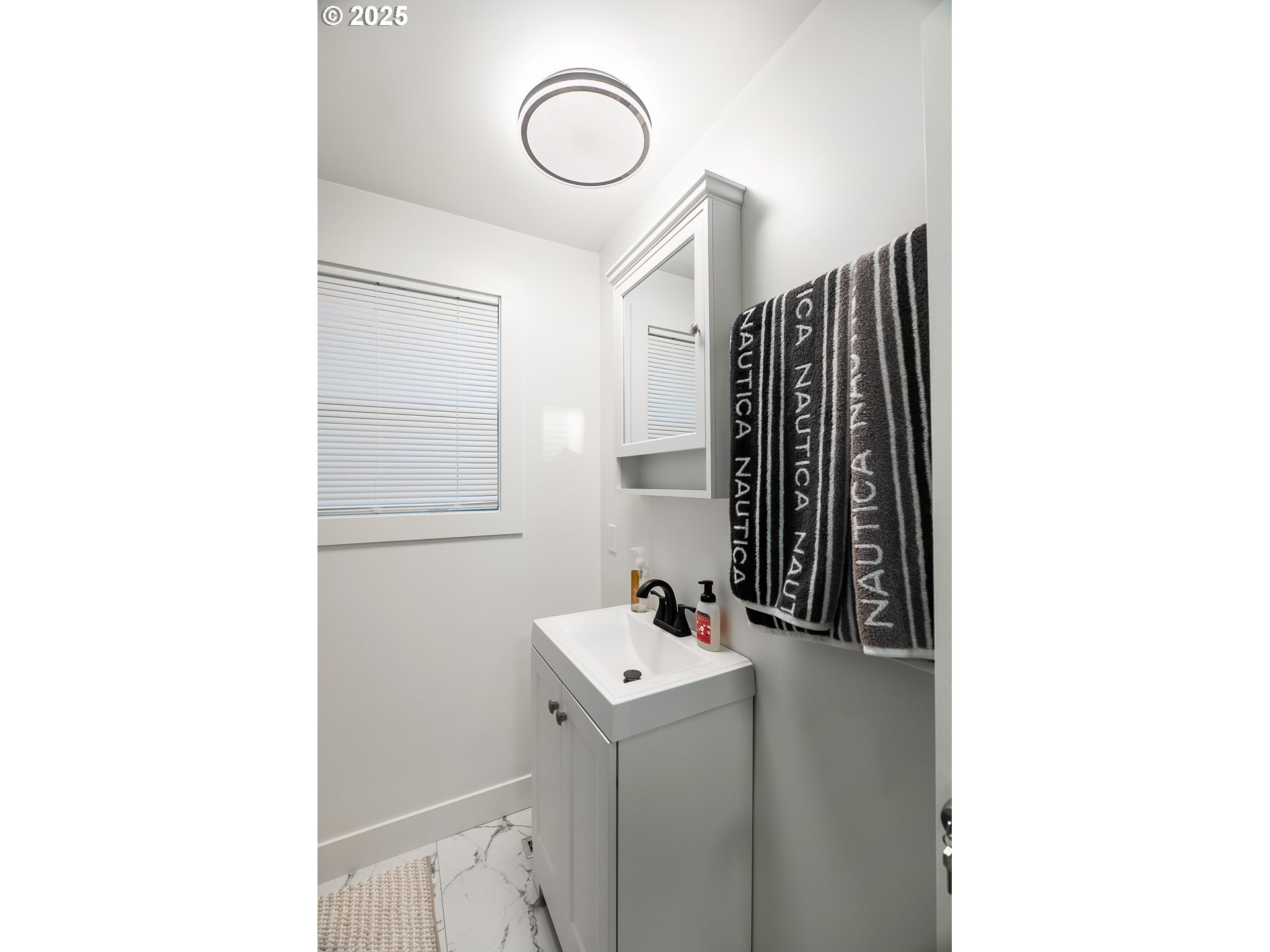 815 North King Street Seaside, OR 97138 - Photo 19 of 33 a bathroom with a sink and a mirror