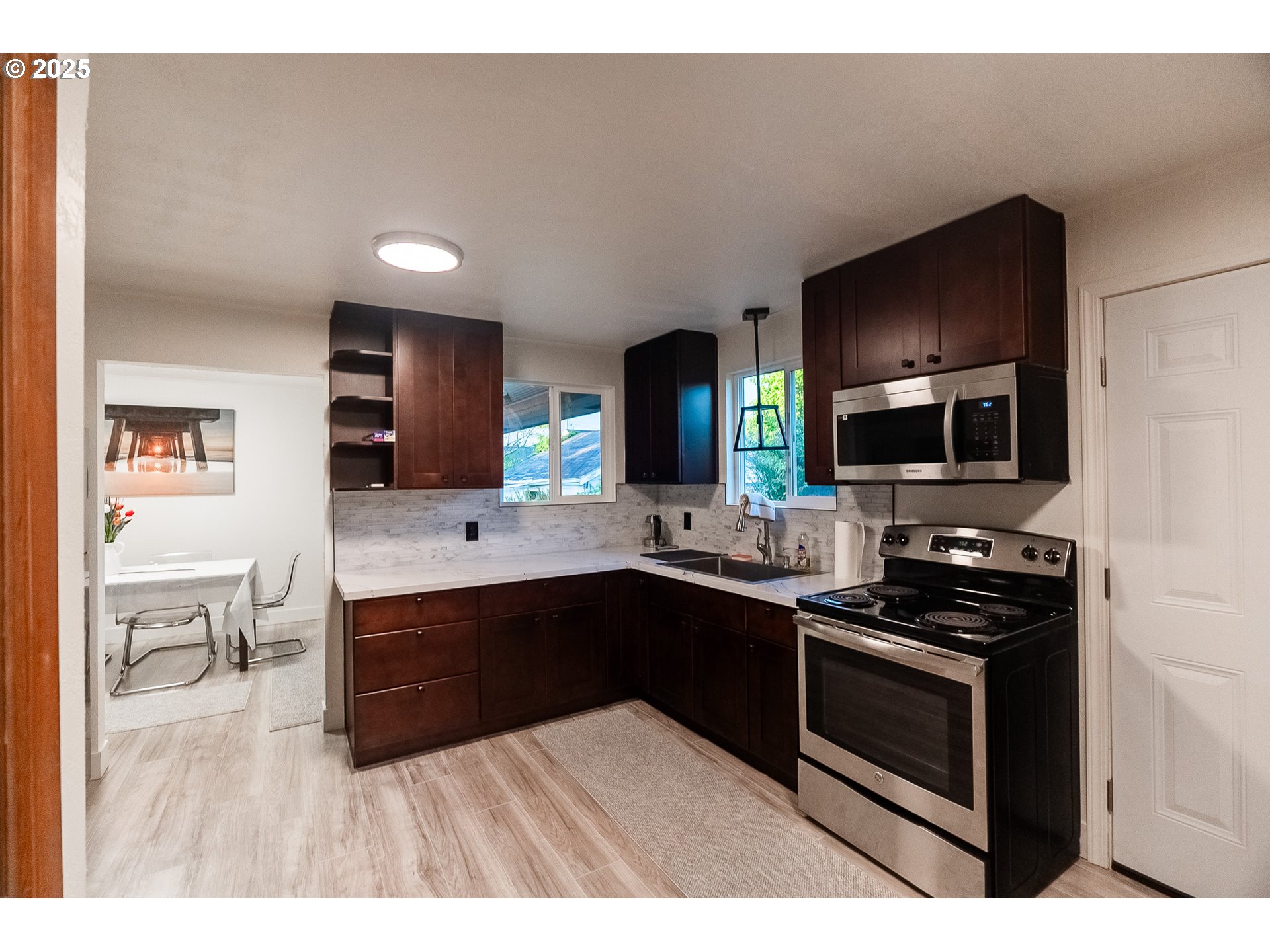 815 North King Street Seaside, OR 97138 - Photo 8 of 33 a kitchen with stainless steel appliances a stove sink microwave and cabinets