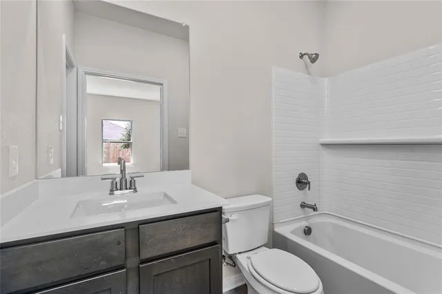 a bathroom with a sink toilet a bathtub and vanity
