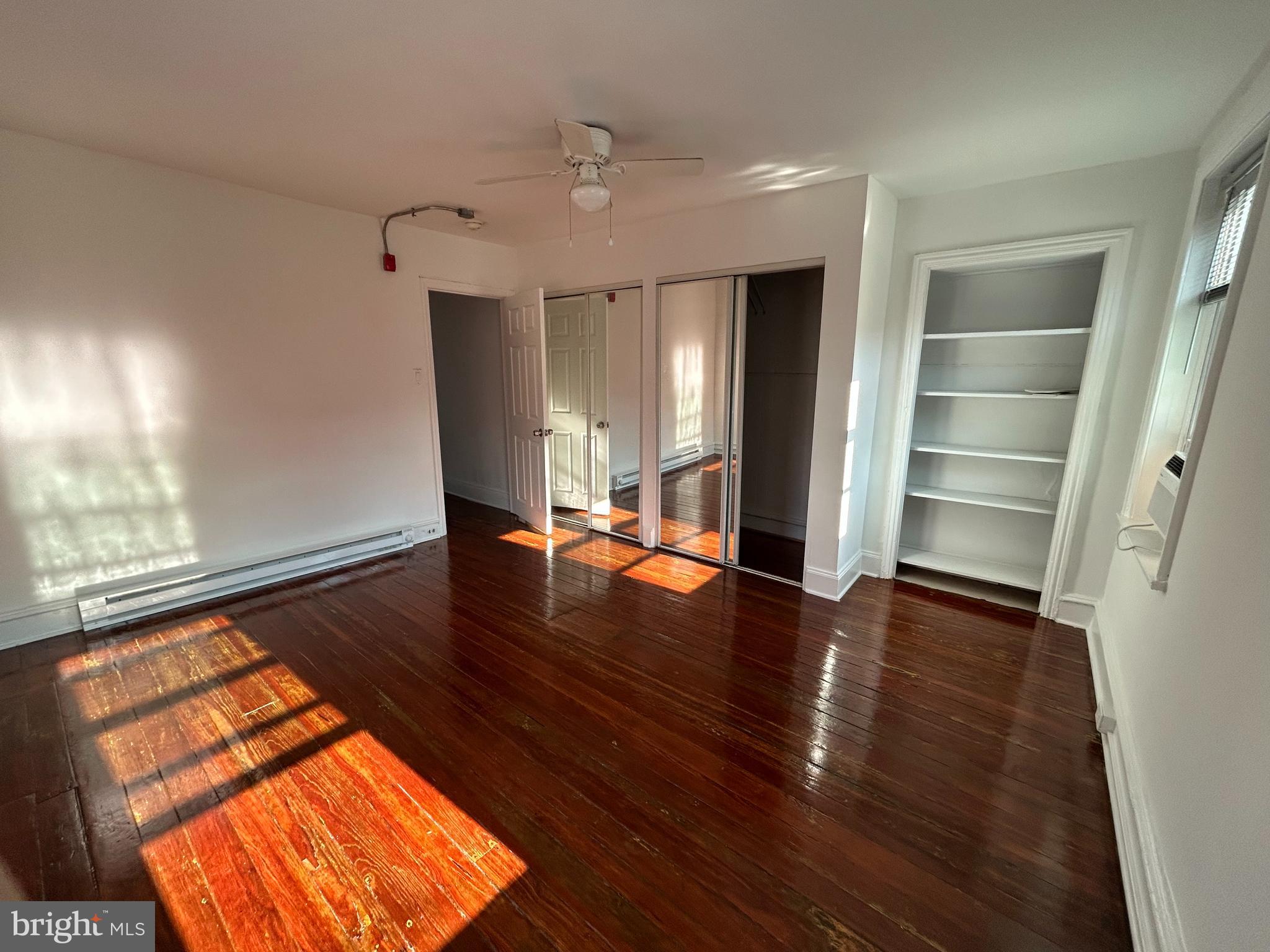 wooden floor in an empty room with a window