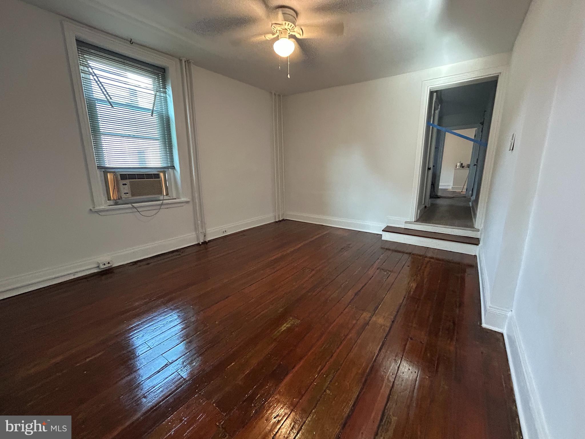 3700 Midvale Avenue, Unit 2 Philadelphia, PA 19129 - Photo 2 of 13 an empty room with wooden floor and windows