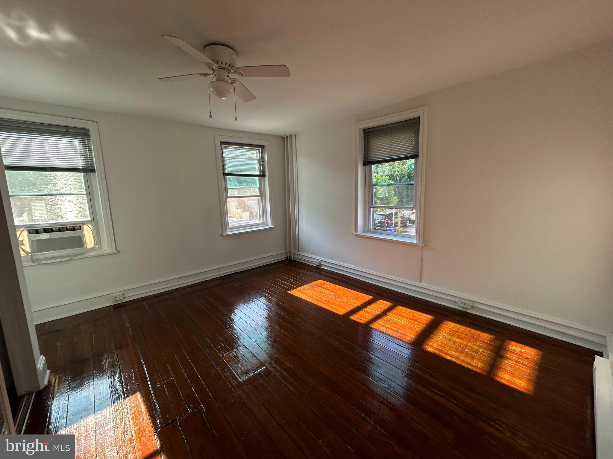 3700 Midvale Avenue, Unit 2 Philadelphia, PA 19129 - Photo 6 of 13 a view of an empty room with wooden floor and a window