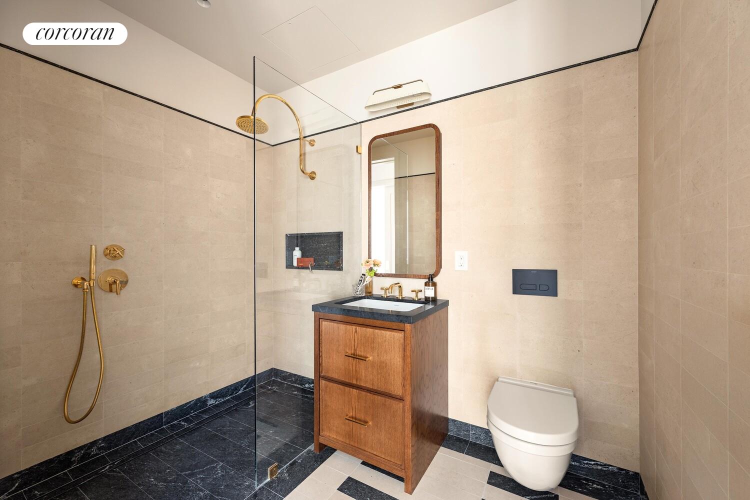 127 Kent Avenue, Unit 2C Brooklyn, NY 11249 - Photo 8 of 22 a bathroom with a granite countertop sink a toilet and a shower