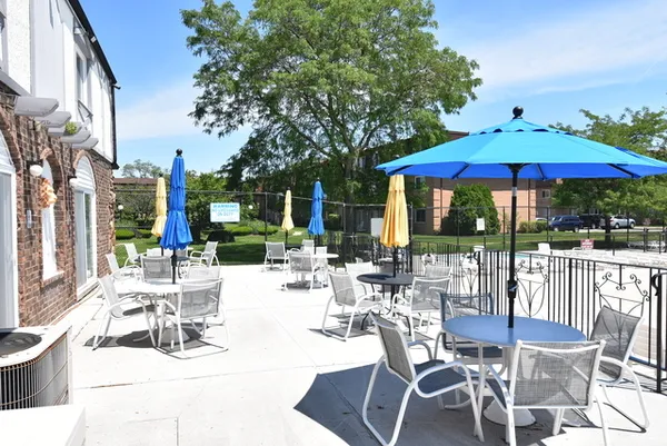 a view of a lake with a yard and large trees