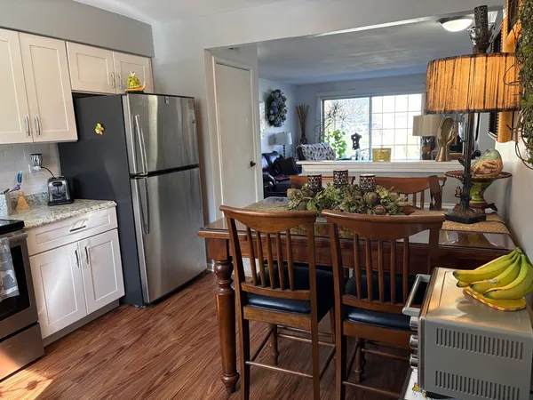 a kitchen with stainless steel appliances granite countertop a refrigerator a stove a sink dishwasher and wooden cabinets