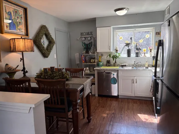 a kitchen with a table chairs refrigerator and stove