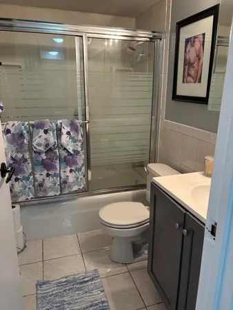 a bedroom with a bed and a potted plant