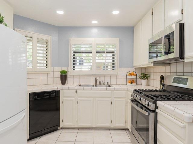 121 Redding Road, Unit B Campbell, CA 95008 - Photo 8 of 15 a kitchen with stainless steel appliances a stove sink microwave and cabinets