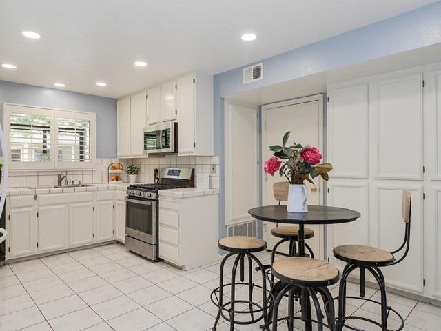 121 Redding Road, Unit B Campbell, CA 95008 - Photo 9 of 15 a kitchen with stainless steel appliances kitchen island granite countertop a sink and cabinets